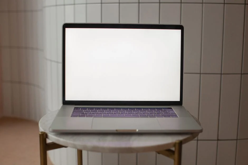 A stylish workspace featuring a laptop and monitors displaying design software.